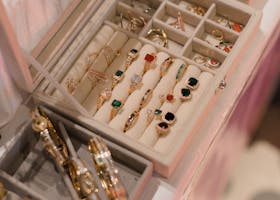 A close-up view of a jewelry box showcasing a variety of elegant rings and bangles in a sophisticated setting.